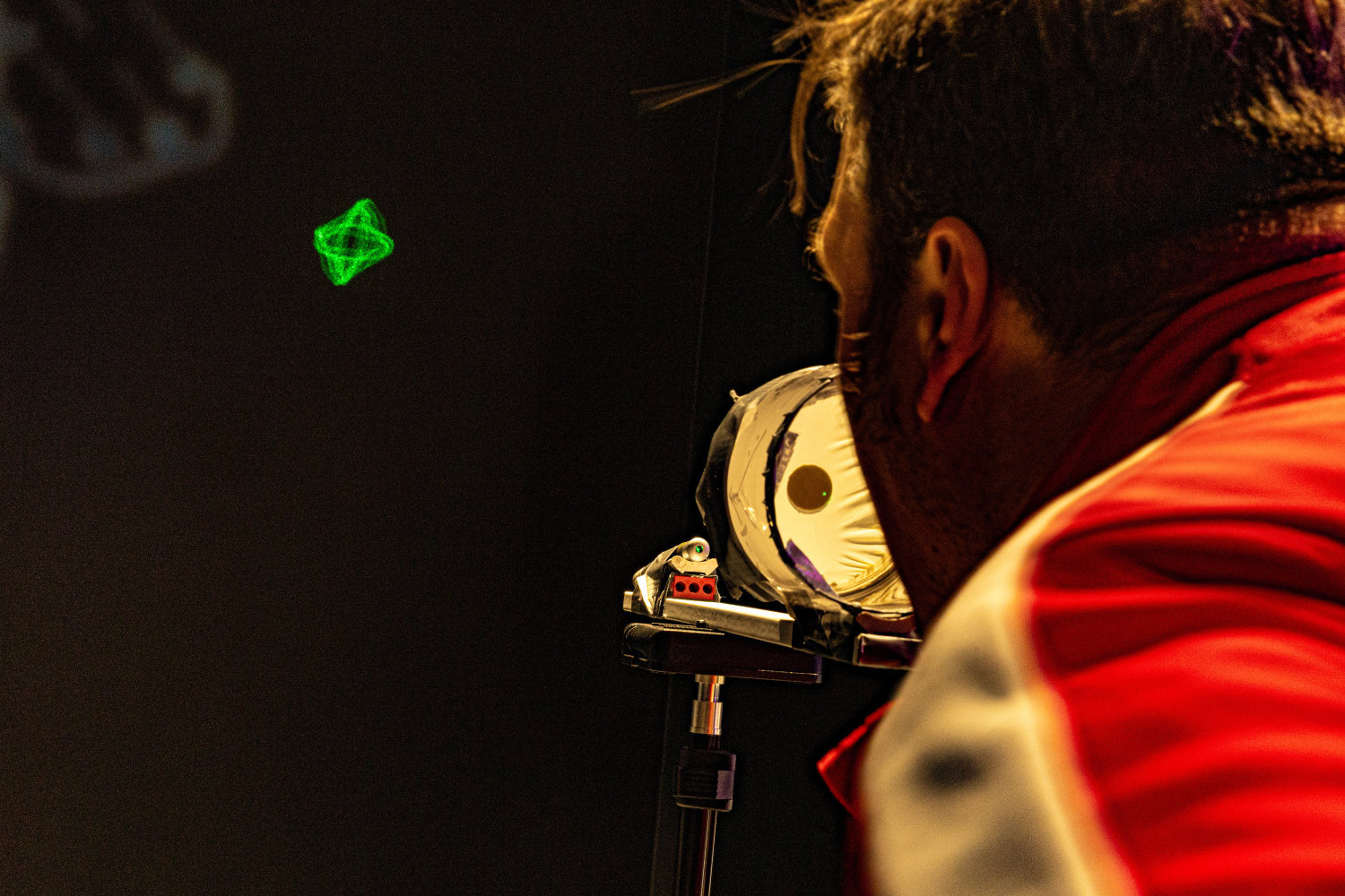 A man singing in a laser-soundvisualiser